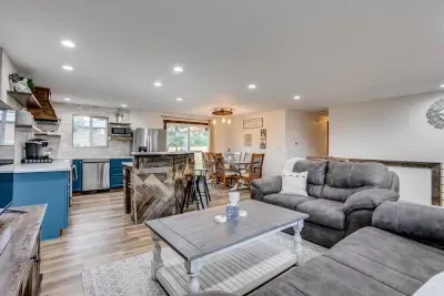 Upstairs living room: Open concept. Coasters. Roku Smart TV for streaming, no cable or satellite. DVD player and DVDs are available in the drawer of the TV stand. Open to dining room and kitchen. Baby gate at the top of the stairs.
