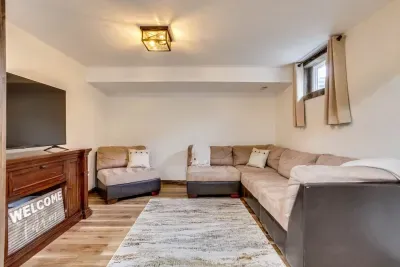 Downstairs, open living room: Roku Smart TV for streaming, no cable or satellite. Cozy area rug and large, comfortable sectional. Warm blankets are provided to curl up in. A couple of throw pillows to finish off the room.