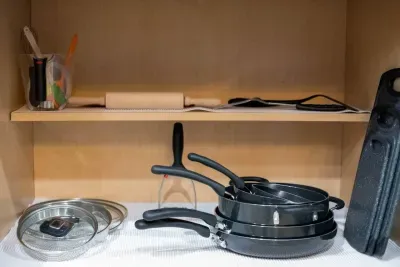 Stocked kitchen: Cutting boards and baking supplies. 17-piece NutriChef Kitchenware Non-Stick pans and pots have cool touch handle grips and see-through lids.