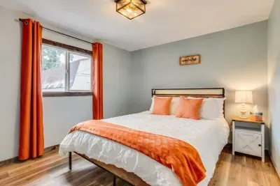 Upstairs orange bedroom: Queen Bed. Outlets USB ports and charging stations are located on the headboard. The headboard has LED lights that can be turned on via the remote located on the headboard. There are 20 color options. Hangers and luggage rack