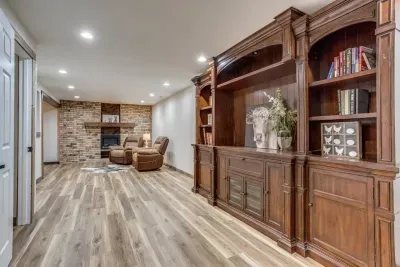 Cuddle up with a book in front of the cozy electric fireplace. Card and board games are located in the cabinets of the bookshelf, along with the chicken & egg tic-tac-toe game found on the bookshelf.