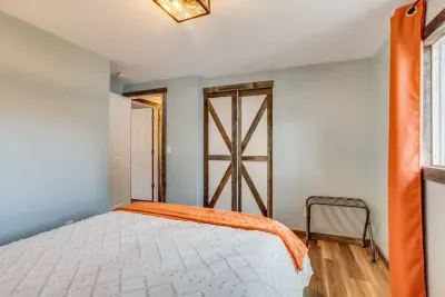 Upstairs orange bedroom: Queen Bed. Outlets USB ports and charging stations are located on the headboard. The headboard has LED lights that can be turned on via the remote located on the headboard. There are 20 color options. Hangers and luggage rack