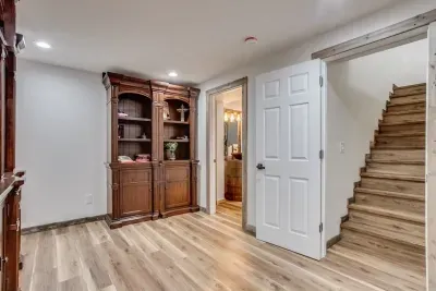 The secret sliding bookcase. Books and games are located in the bookshelf. Door at the bottom of the stairs and baby gate at the top of the stairs.