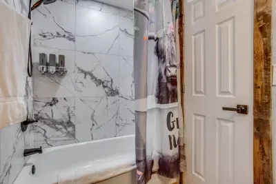 Full bathroom upstairs: Shower and bathtub. Extendable 2-in-1 shower head with 4 spray settings. Custom-made whiskey barrel vanity
Italian shower tile. Custom-built open shelves. There is shampoo, conditioner, and body wash available in the showers.