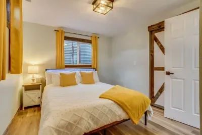 Cheery bedroom and office- behind the secret door: Queen Bed. Outlet charging stations are located on the headboard. The headboard has LED lights that can be turned on via the remote located on the headboard. There are 20 color options. Plus a desk.