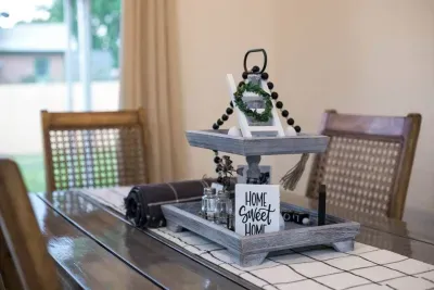 Custom dining table: Salt and pepper shakers, and placemats. The table seats 6 people. Plus 2 people can be seated at the island. Looks out into the backyard with the sliding glass door. Feels like Home Sweet Home