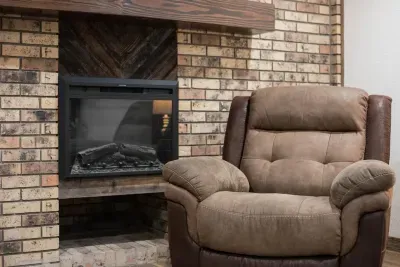 Warm, cozy electric fireplace. Remote functions for the fireplace include 5 levels of flame amount, a timer, a fire cracking sound, and 3 top light colors. The fireplace is finished off with a custom-made mantle.
