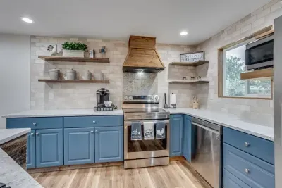 Custom-built range hood, open shelves, and kitchen island. Provided coffee, tea, and hot cocoa Keurig pods. Oven, dishwasher, microwave, full-sized refrigerator, Keurig, sink, cooking utensils,  pots & pans, baking sheet, and more!