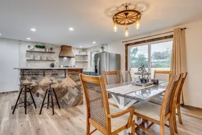 Dining room and kitchen with glass sliding door into the backyard. Seating for 8 people.