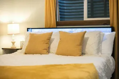 Cheery bedroom and office-behind the secret door:Nightstand and lamp. Queen Bed. Room darkening shades. Outlet charging stations are located on the headboard. The headboard has LED lights that can be turned on via the remote located on the headboard.