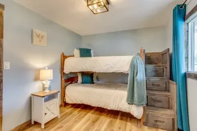 Bunk bedroom- Upstairs: Two twin beds. The closet has hangers, a luggage rack, a wardrobe, and a fan. In every bedroom, there is a throw blanket and two throw pillows. Room darkening shades. We have stairs and storage space in the stairs as well.