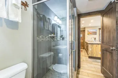 ✨ Clean lines + cozy touches
This modern shower features spa-style tile, a teak bench (not pictured), and easy entry for all ages.

Step out and you’re already in the heart of the home—talk about seamless living.