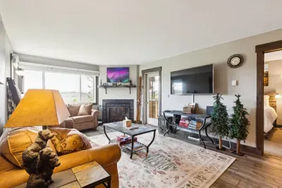 Start your mornings with coffee by the fire and sweeping mountain views—then step out to the balcony and let the adventure begin.