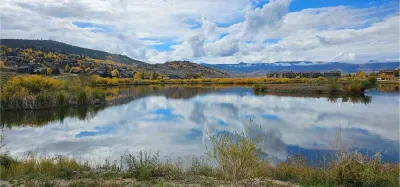 Golden aspens, mountain reflections, and peaceful trails—just steps from your front door. Fall in Granby is pure magic, and this is the view that greets you on your morning walk. Come stay where the colors shine brightest.