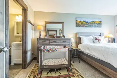 Traveling with littles? We’ve got you covered.
This cozy primary bedroom comes with a pack ‘n play—so you don’t have to haul yours through the mountains. Plus blackout curtains and a fan for a peaceful night’s sleep (for everyone 🙌).