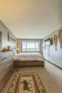 Wake up wrapped in 100% cotton bedding with sweeping views of the valley and sky.
This spacious bedroom blends comfort and charm — featuring a mounted Smart TV, rustic snowshoes, and a front-row seat to the ever-changing Colorado horizon.