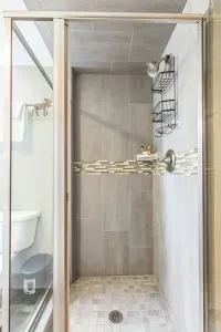 🛁 A shower worth slowing down for...
Framed in glass and wrapped in sleek tile, this walk-in shower features built-in shelving, modern fixtures, and a rustic moose hook just outside for your towel or robe.

It's the perfect way to rinse off a long d