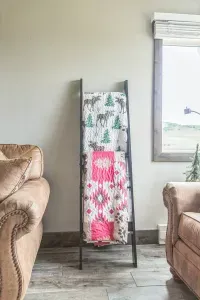 Nothing says “mountain cabin comfort” like a blanket ladder stocked with snuggle-worthy quilts. Grab one, curl up on the couch, and let the views do the rest.