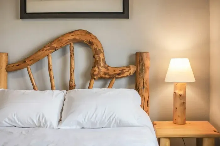 Sleep under the rustic charm of handcrafted woodwork and dreamy forest-inspired linens. Cozy vibes guaranteed! 🌲🛏️ #CabinRetreat #RusticElegance