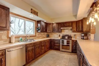 Kitchen: Custom-cabinets and kitchen island. Provided coffee, tea, and hot cocoa. Oven, dishwasher, microwave, full-sized refrigerator, coffee maker, kettle, sink, cooking utensils,  pots & pans, baking sheet, and more!