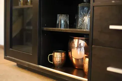 Your perfect toast is waiting! 🥂 Our dry bar cabinet is stocked with style—pour, sip, and unwind with copper mugs and crystal glassware that scream cheers! 🍹