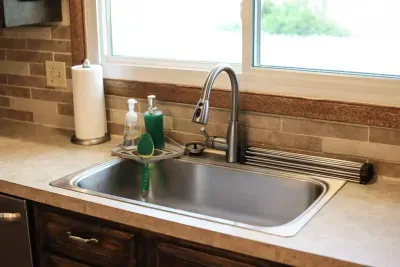 Sparkling clean and ready for action! 🌟 Our kitchen sink area is stocked and prepped for all your culinary adventures. #VacationReady #StaySparkling