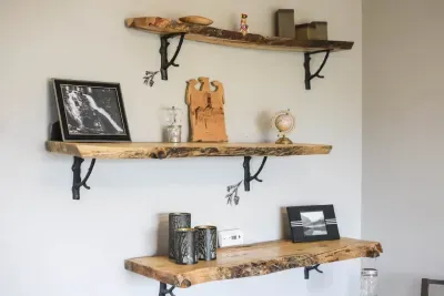 Nature’s touch. Handcrafted live-edge shelves hold treasures from near and far, adding a rustic charm to your cozy getaway. #RusticRetreat #DetailsMatter