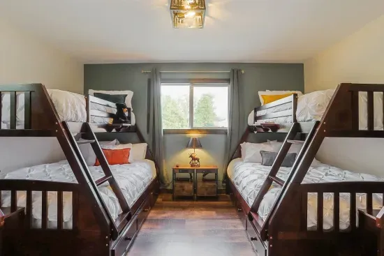 - Room darkening curtains  - 2 Twin over Full bunk beds - Premium mattress  - Premium bedding  - Premium mattress and pillow protectors  - USB and outlet Charging Station on nightstands - Throw blankets - Throw pillows - Mountain decor