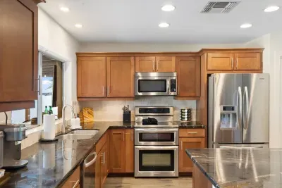 Fully stocked kitchen with pots, pans, and dishware — ready for home-cooked meals and entertaining