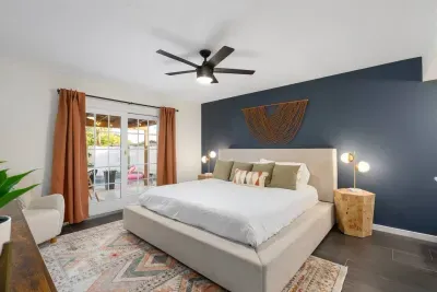 Spacious Bedroom: Bright mornings await with plush bedding and a private patio view!