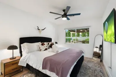The modern western-themed king bedroom offers a unique blend of rustic charm and contemporary comfort, featuring a plush king-sized bed, warm wood accents, and stylish western-inspired decor.