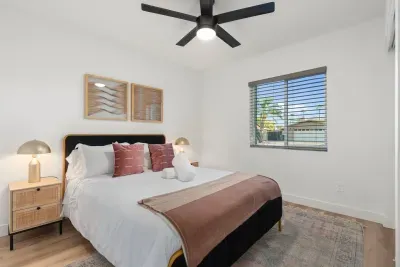 The serene guest room provides a peaceful retreat with a comfortable queen-sized bed, soft linens, and calming decor for a restful night's sleep.