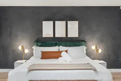 The sleek, modern king bedroom boasts a comfortable king-sized bed, a smart TV for entertainment, and stylish decor for a relaxing stay.