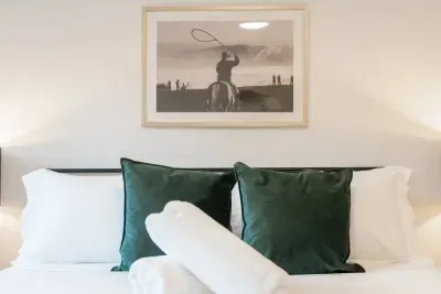 Bedroom Oasis: Plush pillows and western-themed art create an inviting retreat for relaxation.