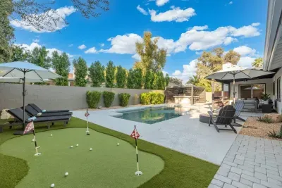 Backyard includes mini-golf course and comfortable lounge chairs for relaxation and entertainment.
