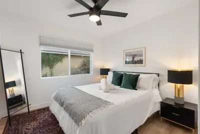 The queen guest room offers a unique blend of rustic cowboy charm and modern elegance, featuring a comfortable queen-sized bed, sleek furnishings, and stylish western-inspired accents.