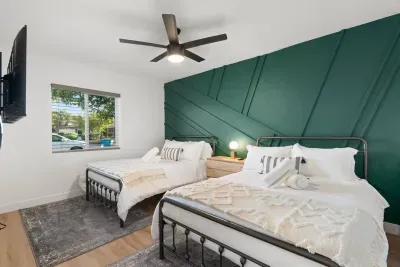 This guest room offers a fun and flexible space to relax and unwind with two comfortable full-sized beds and flat-screen TV.