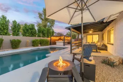 Backyard Paradise: Dive into fun with a heated pool, bubbling hot tub, and evening firepit glow!