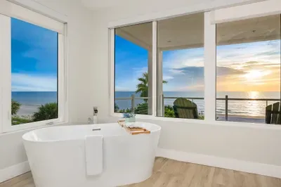 Indulge in luxury with a soaking tub surrounded by panoramic windows. Soak while gazing out at endless ocean views — the ultimate retreat after a day at the beach.