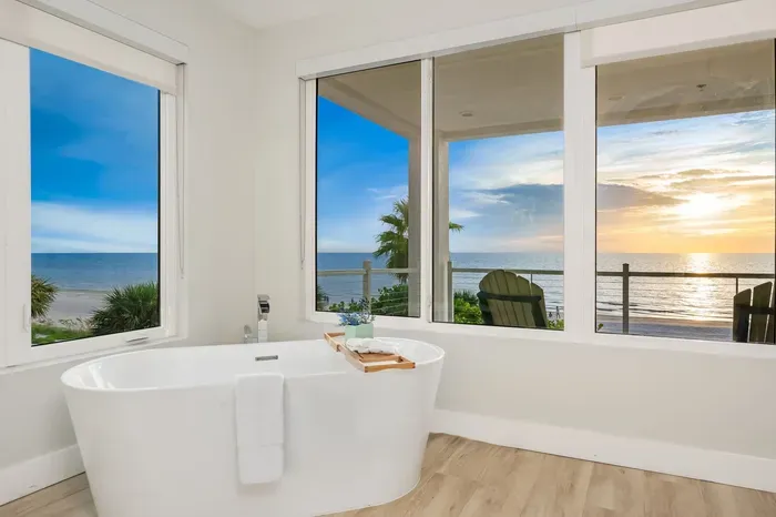 Indulge in luxury with a soaking tub surrounded by panoramic windows. Soak while gazing out at endless ocean views — the ultimate retreat after a day at the beach.