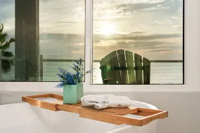 Take your self-care routine to the next level — this deep tub offers a serene view of the ocean and sunsets right outside the window.