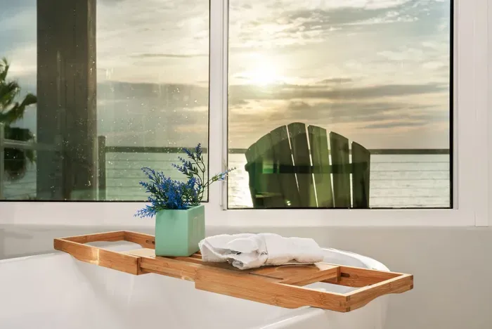 Take your self-care routine to the next level — this deep tub offers a serene view of the ocean and sunsets right outside the window.