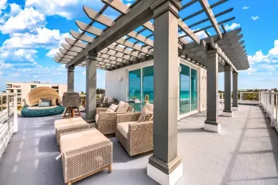 Unwind on the spacious rooftop terrace featuring cozy lounge seating, shaded pergola, and fresh coastal breezes. Perfect for sunset cocktails, morning coffee, or relaxing under the open sky with stunning views all around!