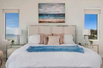 Enjoy a spacious master suite designed for comfort and style. With plush bedding and seaside artwork, it’s a peaceful escape after a day in the sun.