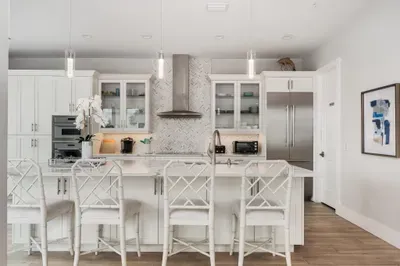 The open-concept kitchen connects seamlessly to the dining and living spaces, ensuring everyone stays connected while meals are prepared.