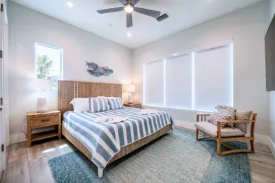 Drift into comfort in this beautifully designed king bedroom featuring a plush bed, coastal-inspired décor, and soft natural light. A peaceful, stylish retreat perfect for restful nights after a day by the beach! (New king bed)