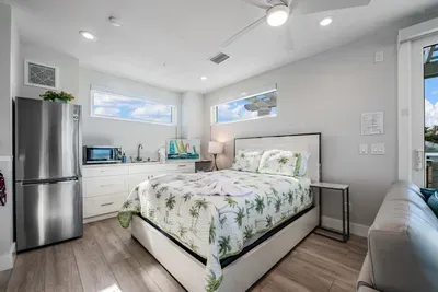 Unwind in this bright and airy bedroom featuring a plush bed, coastal-inspired décor, and natural light throughout. With added convenience of a mini fridge and cozy seating, it’s the perfect private retreat after a relaxing beach day!
