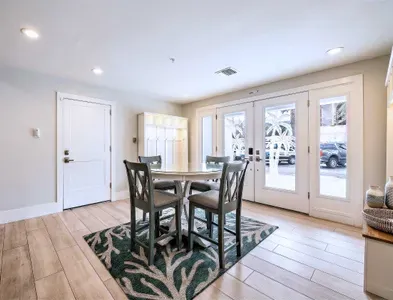 Enjoy meals and game nights in this bright dining area with stylish seating and natural light. French doors open to outdoor spaces, creating a seamless indoor-outdoor flow—perfect for gathering, relaxing, and making lasting memories!