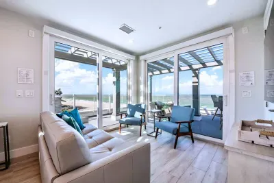 Bright corner lounge with floor-to-ceiling views of the ocean and direct balcony access. Relax on plush seating, enjoy coastal breezes, and soak in the natural light—an inviting space to unwind, read, or gather with friends by the sea!