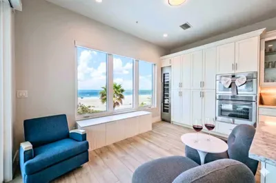 Enjoy a cozy coastal retreat with stunning ocean views, plush seating, and abundant natural light. Sip wine by the window, relax in comfort, and take in the serene beachfront scenery from this inviting and stylish space!